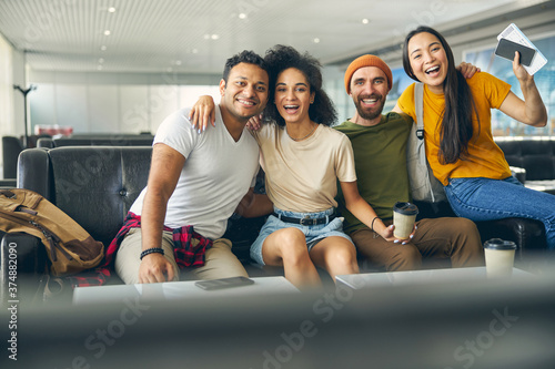 Young people hanging fun together in airport while waiting their flight