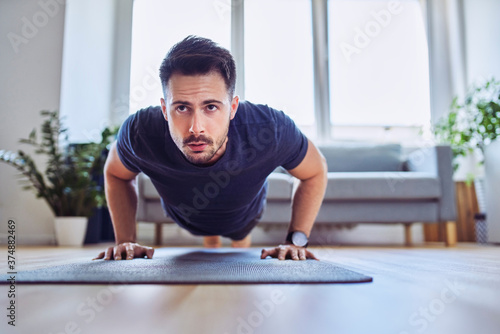 Training at home. Closeup of man doing pushups at home