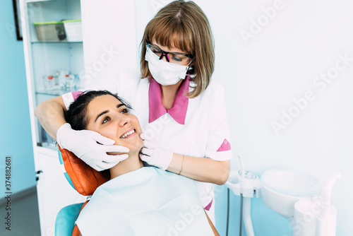 Dental examination of the patient. Dentist curing a woman patient in the dental office in a pleasant environment. Dentistry. Dental care. A woman treats her teeth at the dentist. Prevention of caries