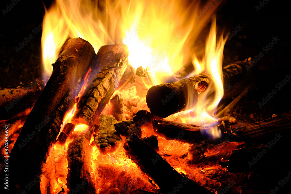 Naklejka premium Fire was lit, hot coals in the fire from the burning logs.
