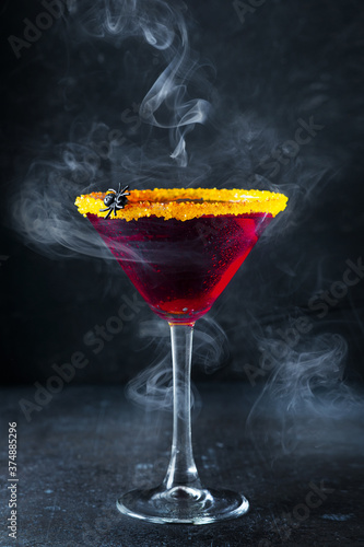 Fotografie Halloween coctail black widow with red drinks in glass on dark background