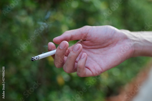Stop smoking and Quit smoking cigarettes concept. Handsomeman holding broken cigarette in hands. Quit bad habit, health care concept.