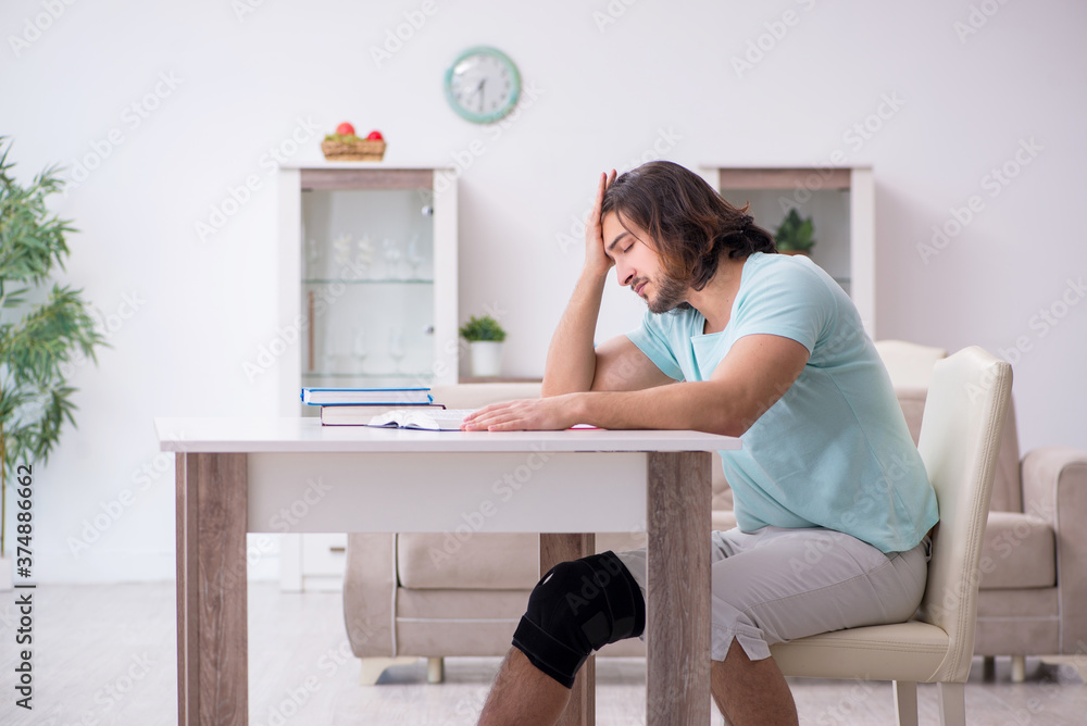 Young leg injured student studying at home Young leg injured student studying at home