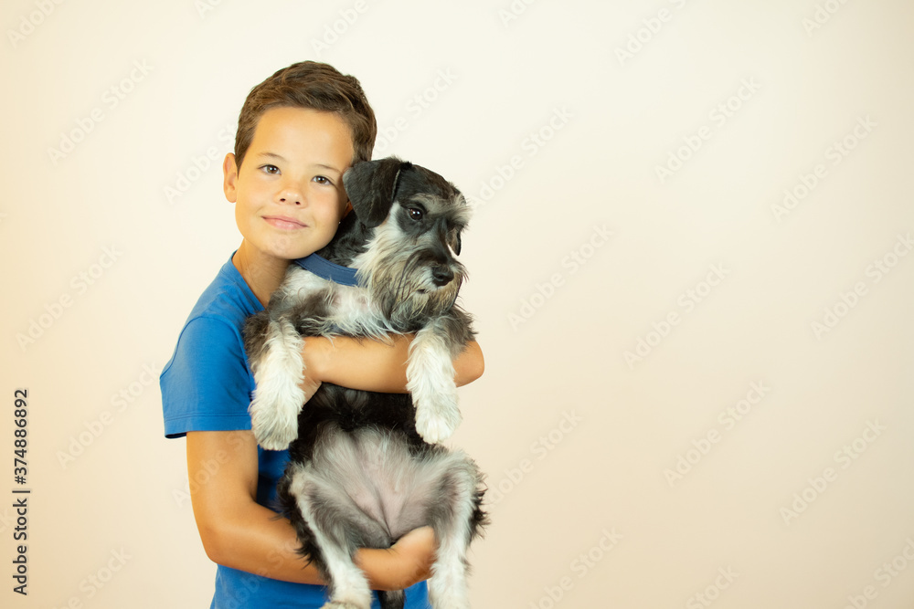 Handsome boy smiling with his dog in his arms Handsome boy smiling with his dog in his arms