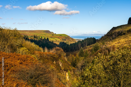 Panoramic view on the valley of Glenariff Forest Park in autumn colours with Scotland shore in far distance, Count Antrim, Northern Ireland