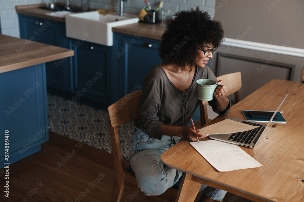 Smiling young female entrepreneur working on laptop Smiling young female entrepreneur working on laptop