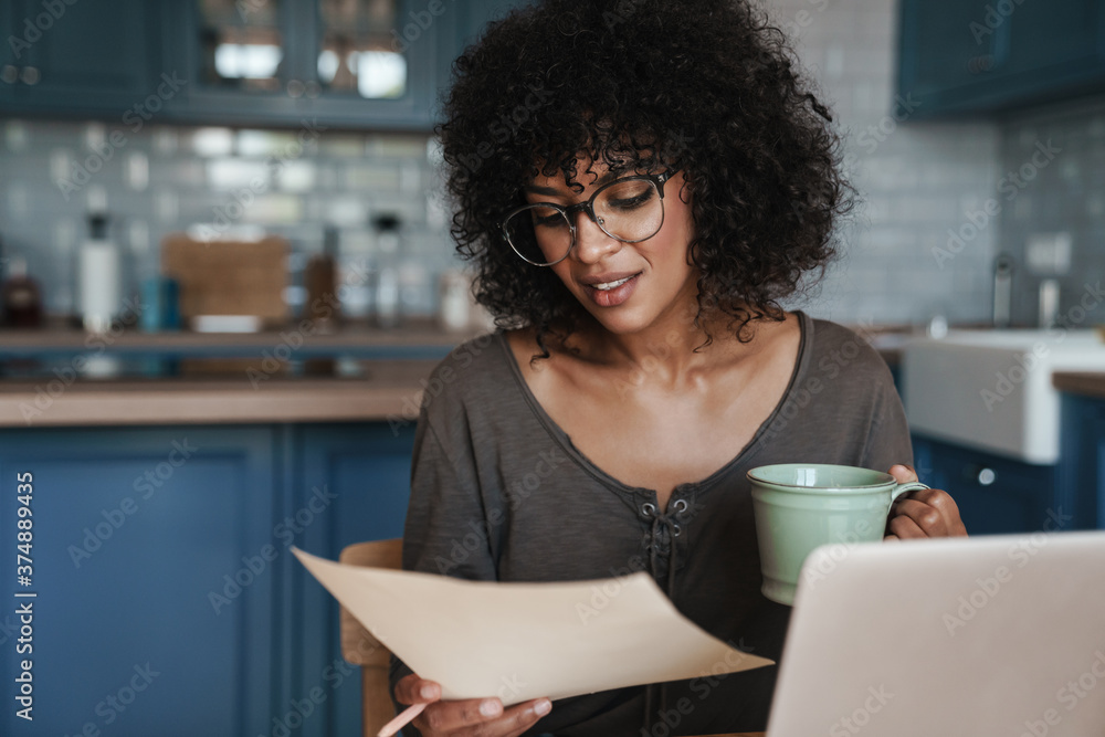 Smiling young female entrepreneur working on laptop Smiling young female entrepreneur working on laptop