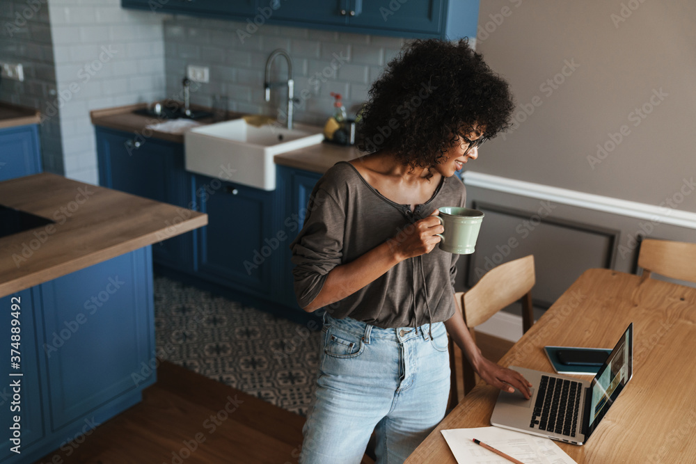 Smiling young female entrepreneur working on laptop Smiling young female entrepreneur working on laptop