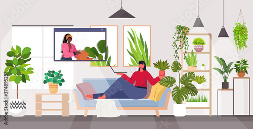 woman taking care of houseplants housewife discussing with friend in web browser window during video call full length horizontal vector illustration