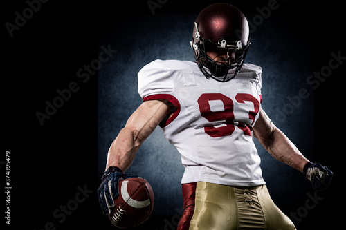 American football sportsman player on stadium with lights on background