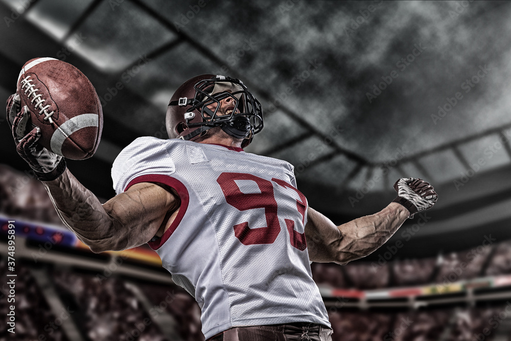 Fototapeta premium American football sportsman player on stadium with lights on background