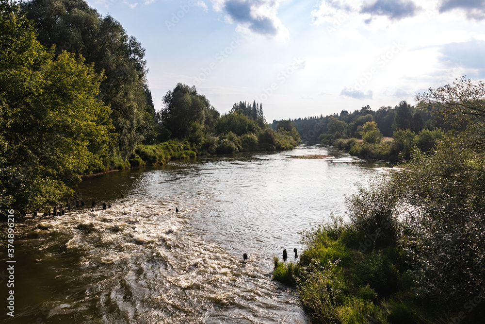 Scenic panorama of river flowing between the banks