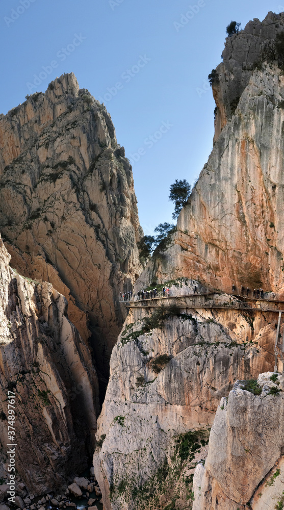 Hikers with helmets on the famous Caminito del Rey footpath near El Chorro, Andalucia, Spain