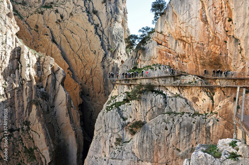 Hikers with helmets on the famous Caminito del Rey footpath near El Chorro, Andalucia, Spain