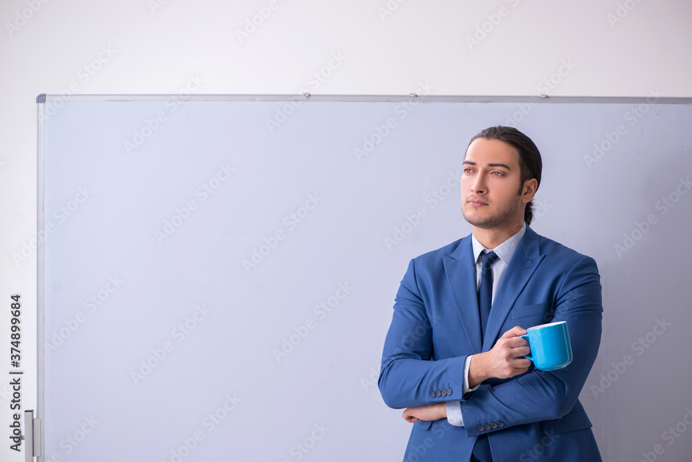 Young man employee in business presentation concept Young man employee in business presentation concept
