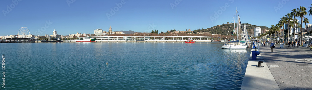 Fototapeta premium Malaga, Spain: Muelle one and two, the beautifully restored central harbour piers in the centre of town on a bright winter day