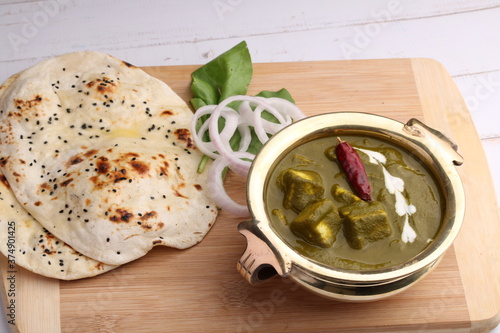 Palak paneer or Spinach and Cottage cheese curry is a healthy main course recipe in India, served with Naan. photo