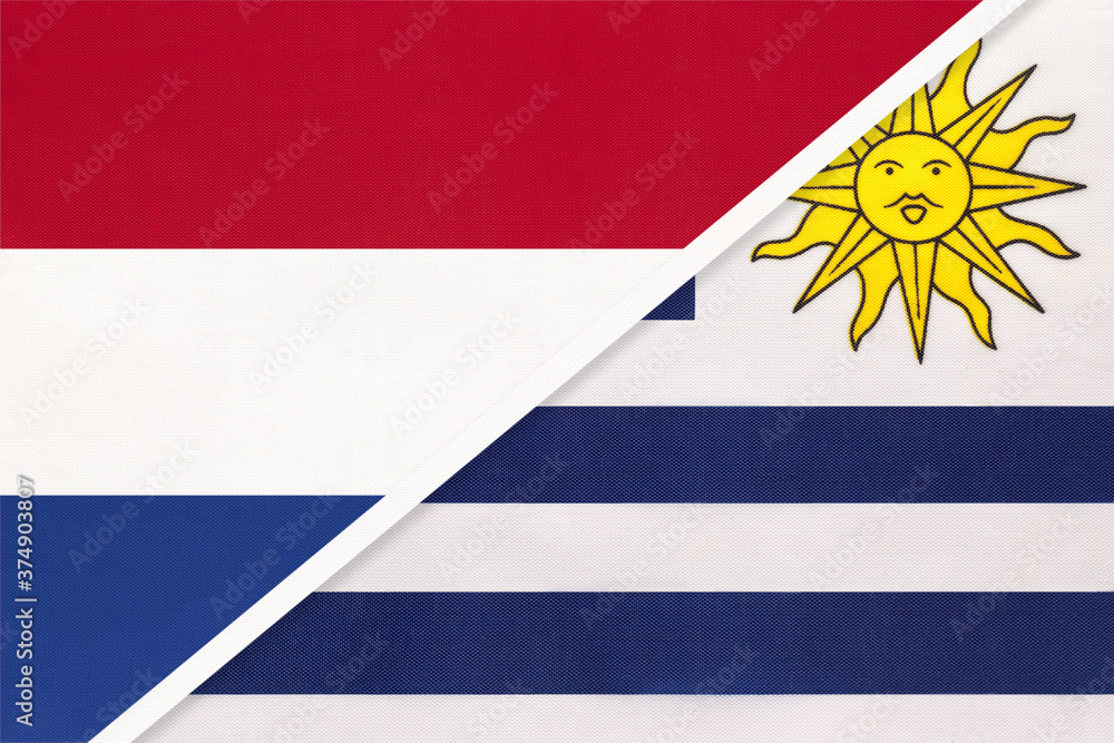 Fototapeta premium Netherlands or Holland and Uruguay, symbol of national flags from textile. Championship between two countries.