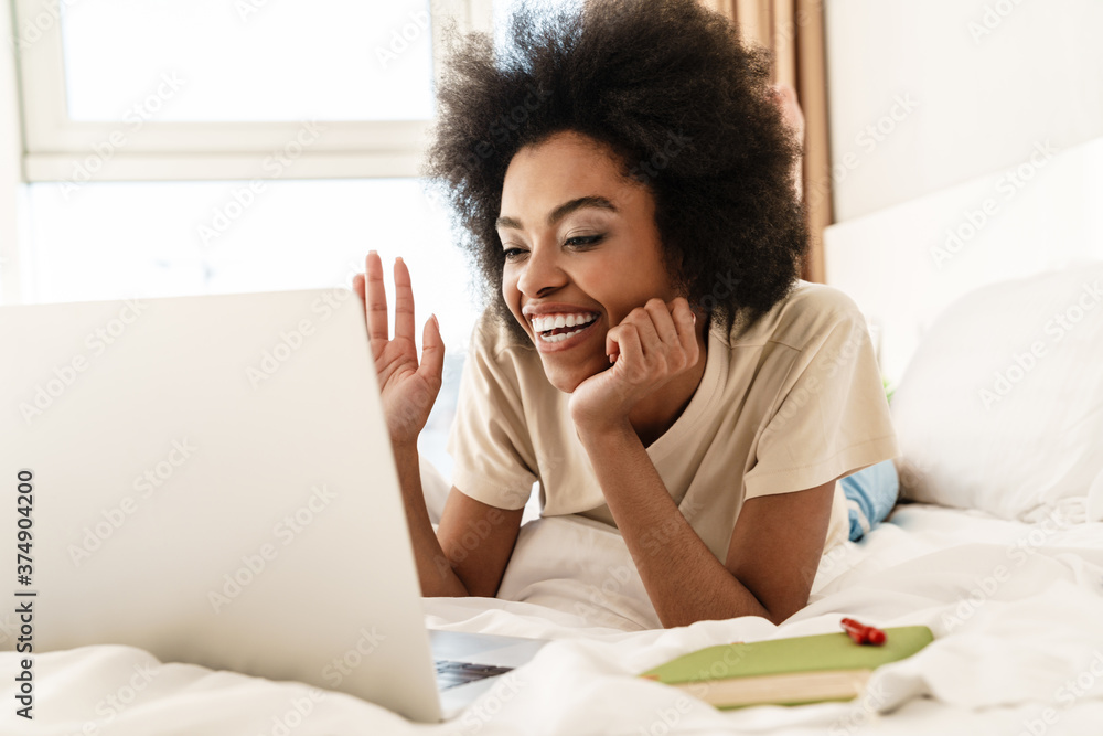 Cheerful young african woman having video chat Cheerful young african woman having video chat