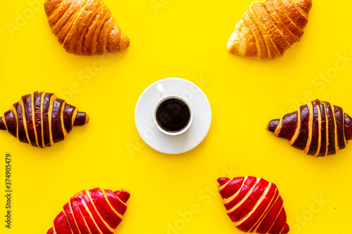 Set of coffee with croissants - chocolate, berry, classic - on yellow table © 279photo