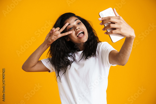 PSmiling young african woman taking selfie