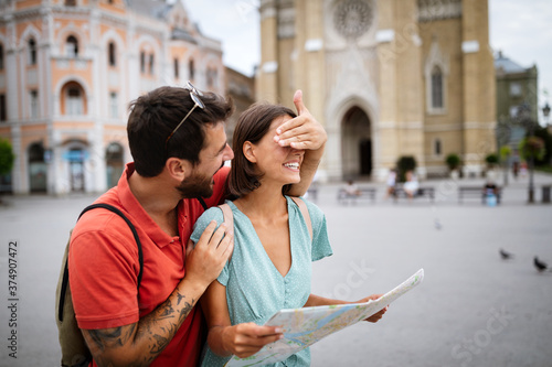 Summer holidays, dating and tourism concept. Smiling couple with map in the city