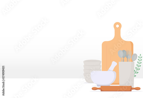 White table with cooking kitchen utensils. White background wall. Fork, spoon, and kitchen plates. China plates and twig with a leaf.