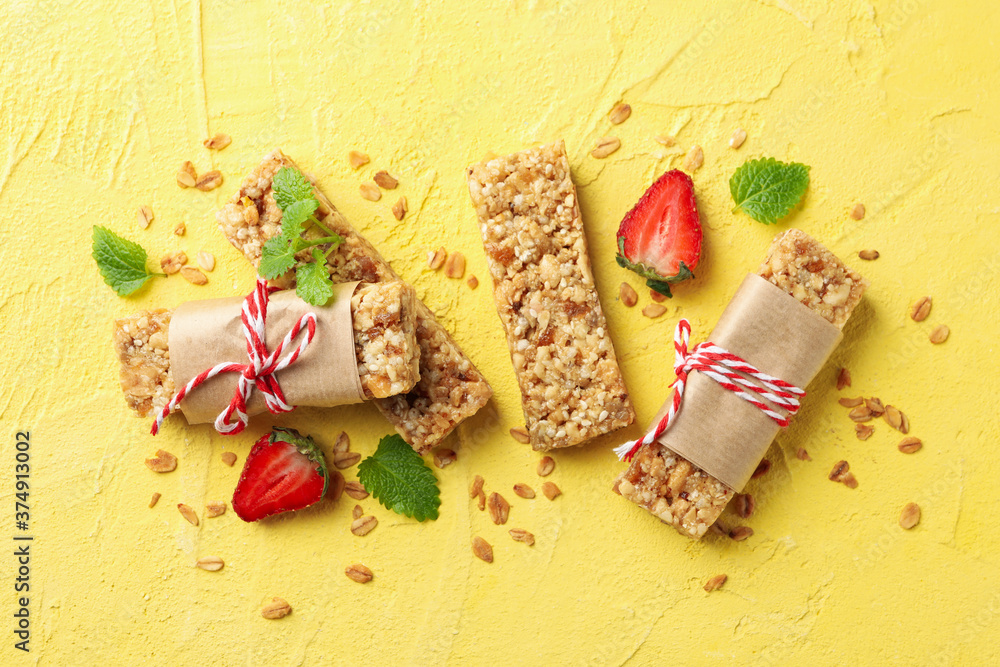 Tasty granola bars on yellow background, top view Tasty granola bars on yellow background, top view