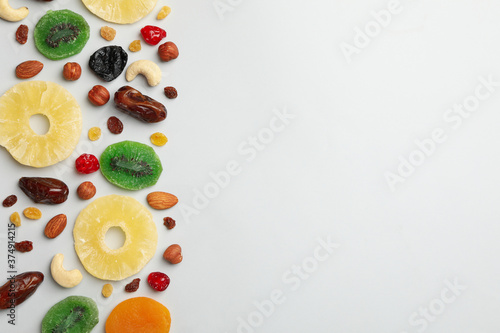 Nuts and dried fruits on gray background  top view