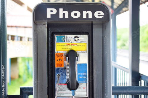Vintage, retro public coin-operated telephone. Phone booth with old fashioned phone. photo