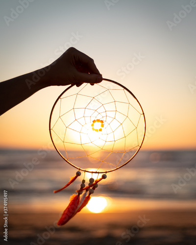 dream catcher  with sunset in the background on the beach