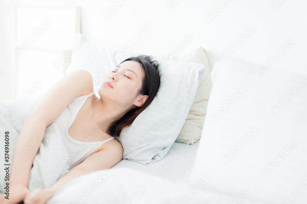 Asian women sleeping in bed