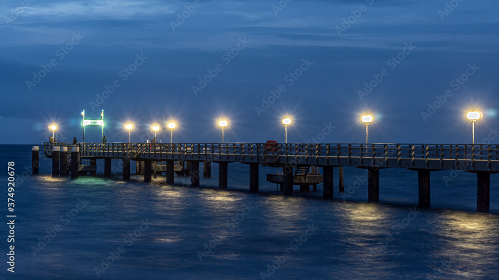 Pier of Kuehlungsborn at Baltic Sea during a mood night