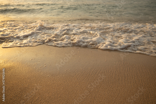 Scenic seascape. Milky foam waves at the beach. Sunset time. Waterscape for background. Selected soft art focus. Sunlight reflection on the water and sand. Balangan beach  Bali  Indonesia