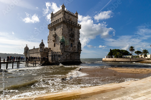 Obraz na płótnie The Tower of Belem surrounded by the ocean and the waves in Lisbon, Portugal w salonie