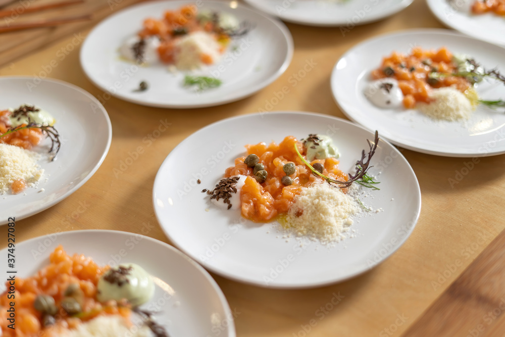 Smoked Salmon Topped with Capers, Cheese, Seeds and Sauce. Gourmet cuisine, luxury catering. Smoked Salmon Topped with Capers, Cheese, Seeds and Sauce. Gourmet cuisine, luxury catering.