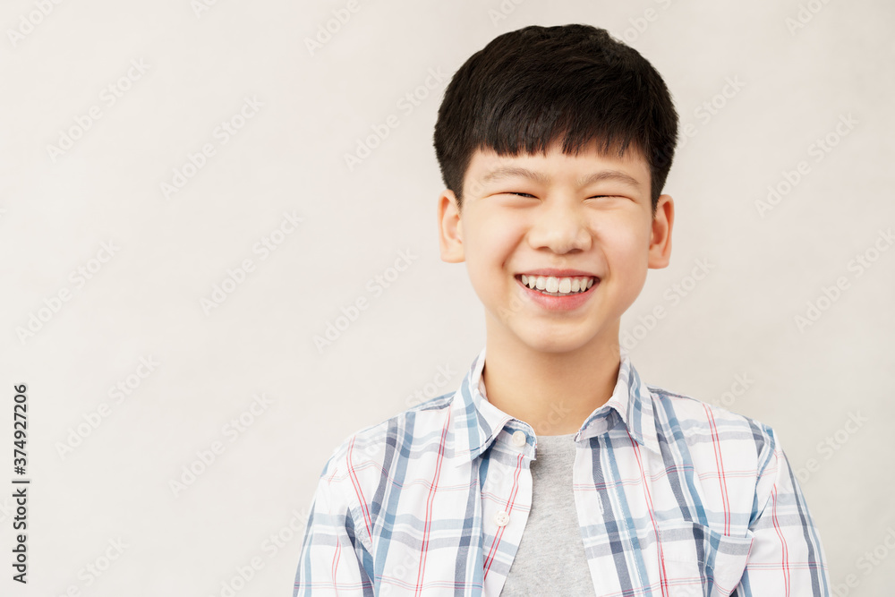 Portrait of handsome and smart looking Asian preteen boy smiling with confident and happy face expression. Healthy early adolescence development concept (physical, mental and emotional) . Portrait of handsome and smart looking Asian preteen boy smiling with confident and happy face expression. Healthy early adolescence development concept (physical, mental and emotional) .