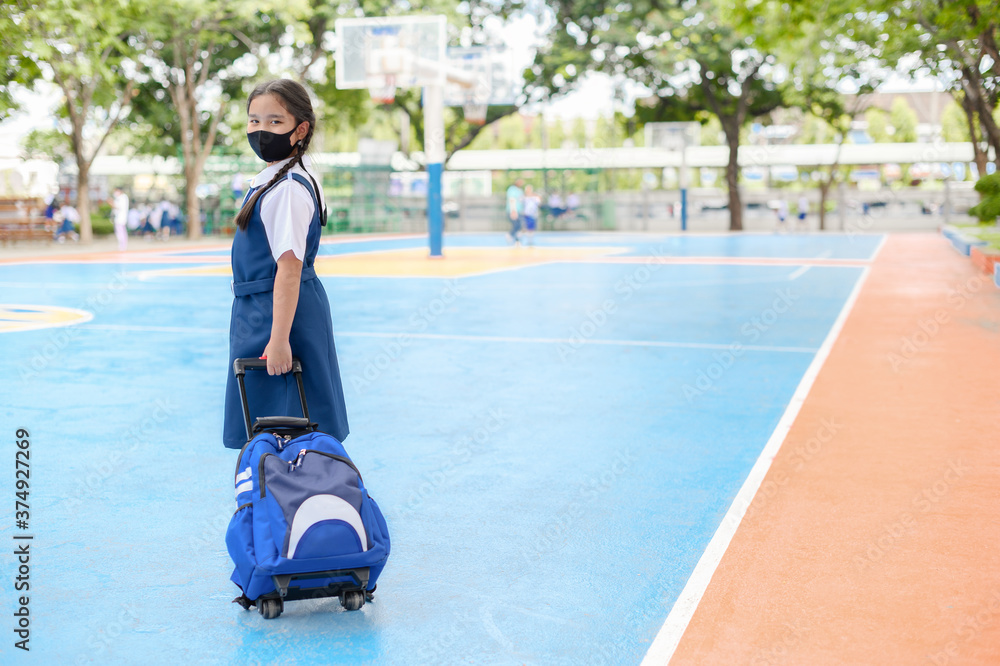 Portrait Asian children girl wear mask to protect PM 2.5 dust and air pollution. Portrait of Thai student wearing protection mask bad weather, concept of Corona virus quarantine,Covid-19 Portrait Asian children girl wear mask to protect PM 2.5 dust and air pollution. Portrait of Thai student wearing protection mask bad weather, concept of Corona virus quarantine,Covid-19