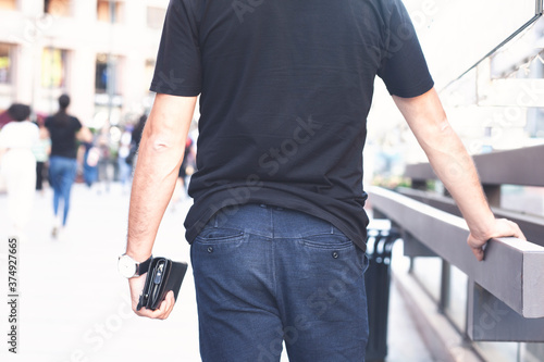 man with wallet in hand, black wallet, brown wallet.