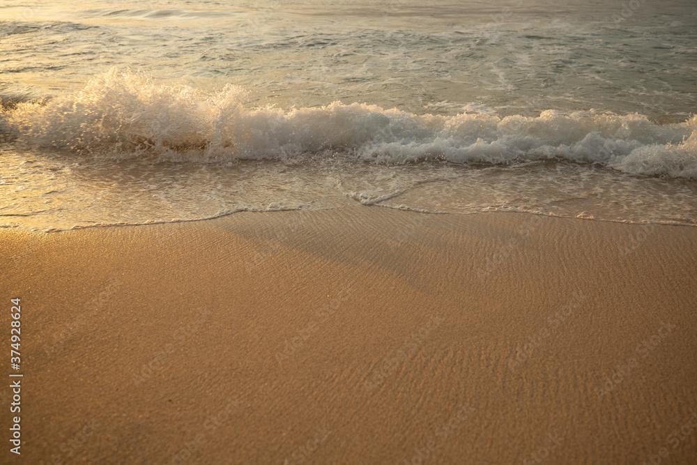 Scenic seascape. Milky foam waves at the beach. Sunset time. Waterscape for background. Selected soft art focus. Sunlight reflection on the water and sand. Balangan beach, Bali, Indonesia