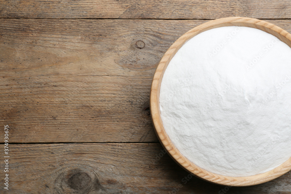 Baking soda on wooden table, top view. Space for text Baking soda on wooden table, top view. Space for text