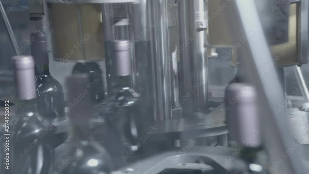 Factory for wine production. Wine factory. Bottles on the bar for filling wine Factory for wine production. Wine factory. Bottles on the bar for filling wine