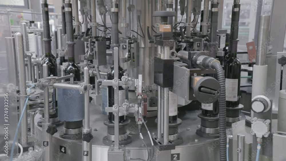 Factory for wine production. Wine factory. Bottles on the bar for filling wine Factory for wine production. Wine factory. Bottles on the bar for filling wine