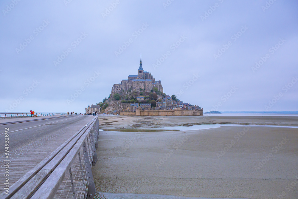 Mont-Saint-Michel and its Bay on a cloudy day in Normandy, France.