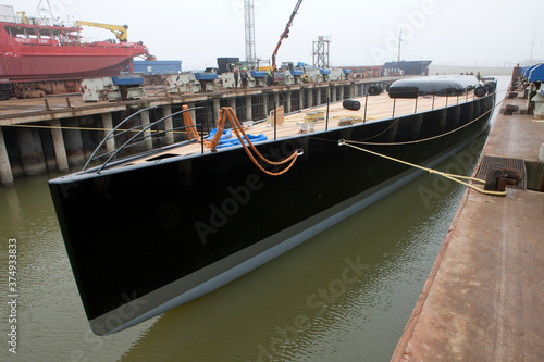 Super sailing yacht in a dock. Ship building industry. Shipyard. Building superyachts. photo