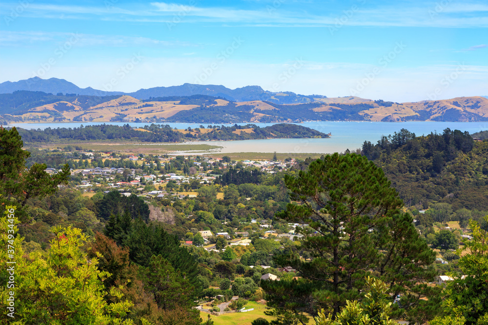 Panoramic view of the small town of Coromandel, New Zealand, seen from the surrounding mountains