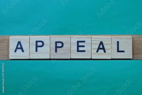 gray word appeal made of wooden square letters on green background