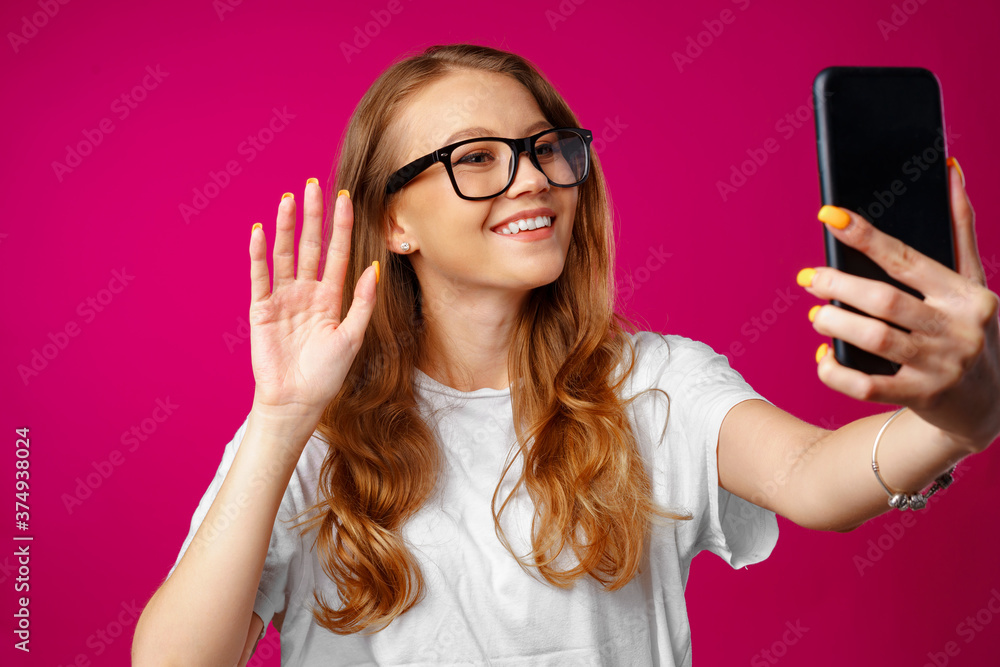 Happy casual young woman smiling and having a video call