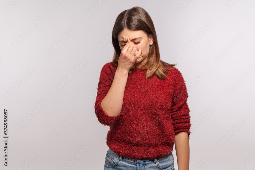 Depression. Portrait of upset girl touching nose and frowning, wiping tears crying, feeling desperate hopeless, coping lonely in emotional stress. indoor studio shot isolated on gray background Depression. Portrait of upset girl touching nose and frowning, wiping tears crying, feeling desperate hopeless, coping lonely in emotional stress. indoor studio shot isolated on gray background