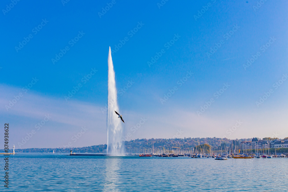 The lake Geneva in Switzerland, with the big water fountain in it, on a sunny day.